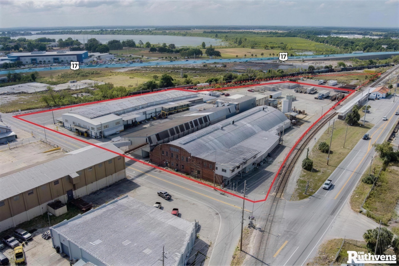 Aerial view of the fenced EZ Truck Parking yard in Winter Haven, Florida, outlined along Ave R SW.