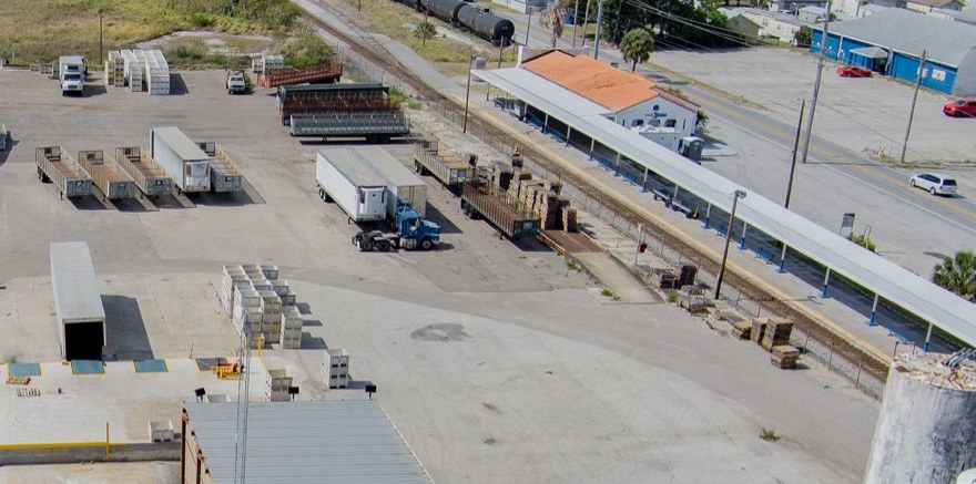 Semi truck and trailers parked by the on-site station inside the Winter Haven yard.