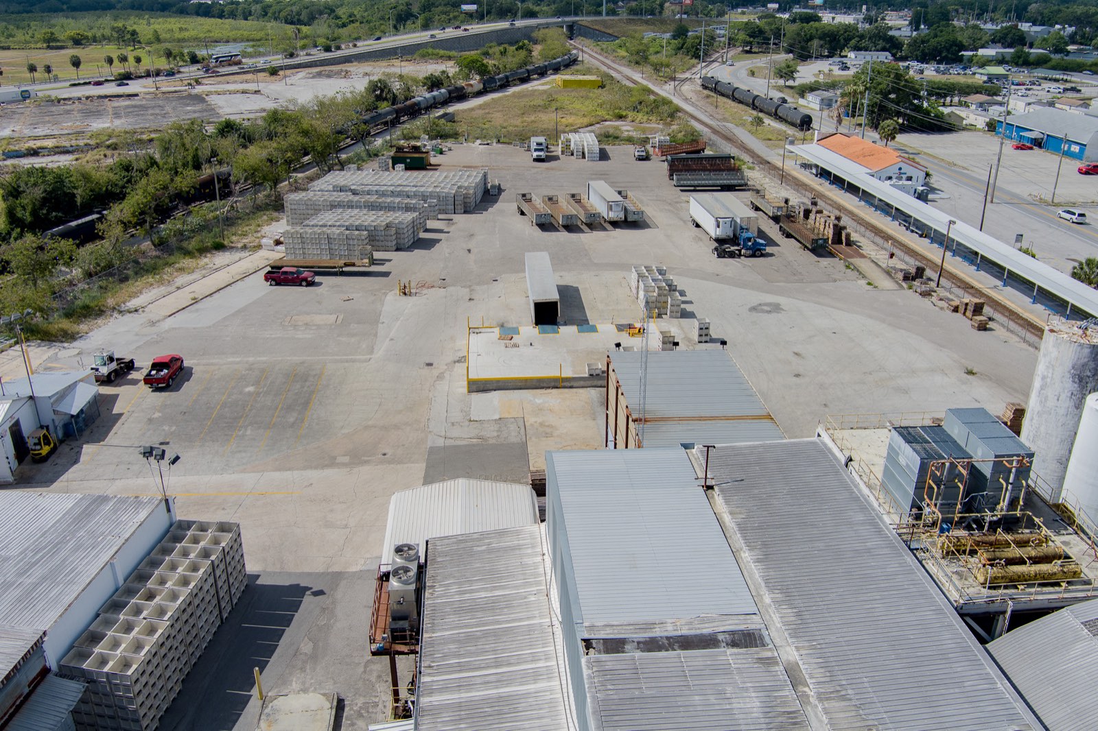 Ground-level aerial of the paved Winter Haven yard with trailers, a loading dock and the on-site truck scale.